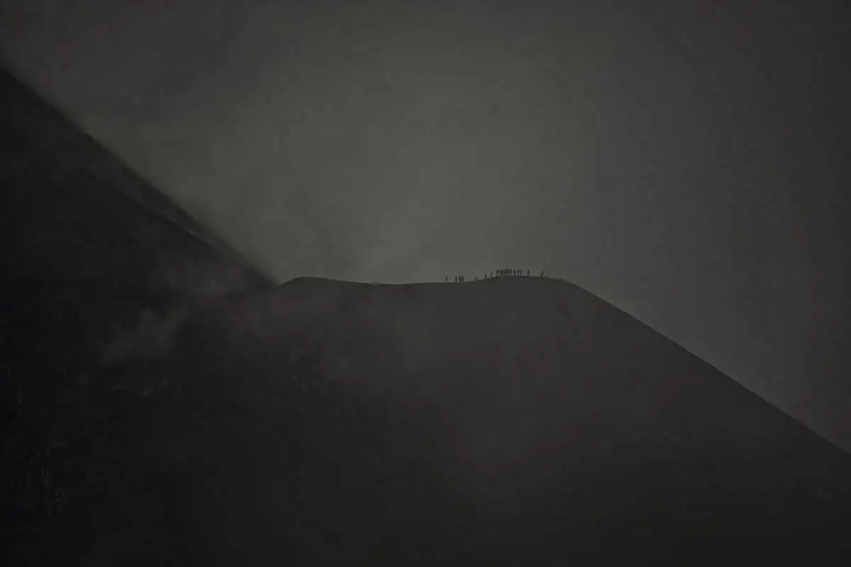hikers on the fuego saddle covered in cloud