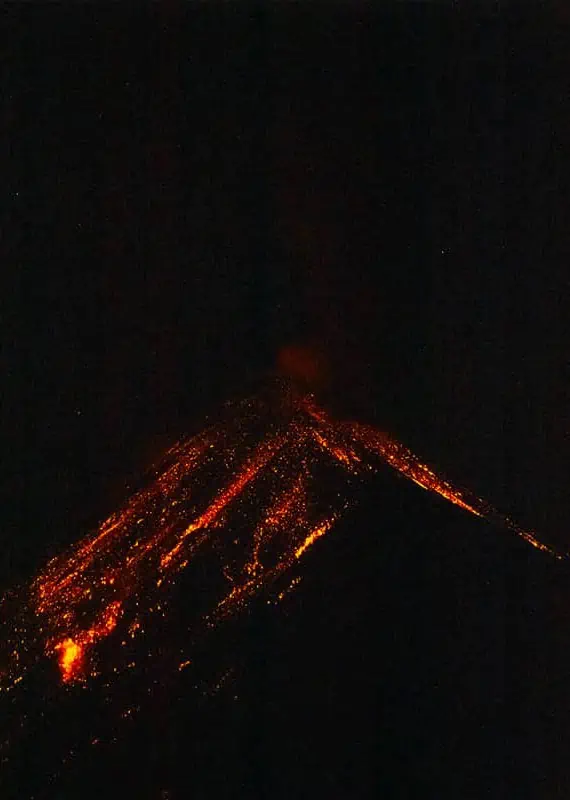 lava lighting up the sky from fuego volcano at night