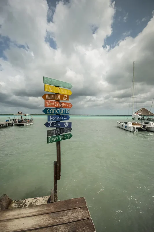 sign in bacalar showing distances to different locations including caye caulker belize