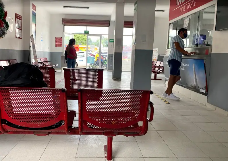 An image of the bus waiting area in bacalar with chairs arranged in rows.