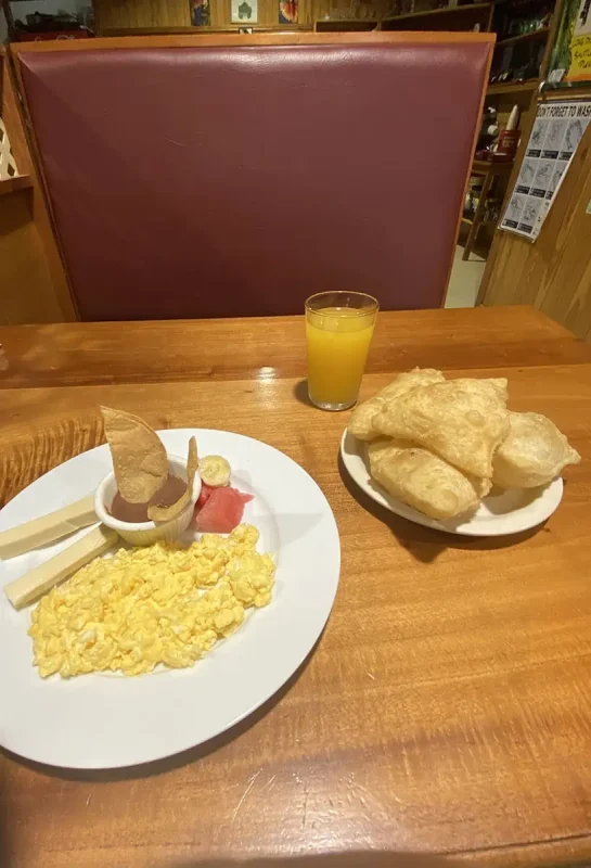 a delicious typical breakfast in belize consisting of fry jacks, beans, and eggs