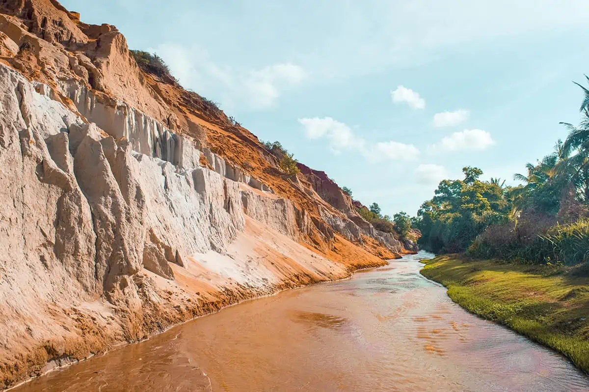 the contrast between the orange cliffs and green jungle on the fairy stream, a must explore on your 2 days in mui ne itinerary