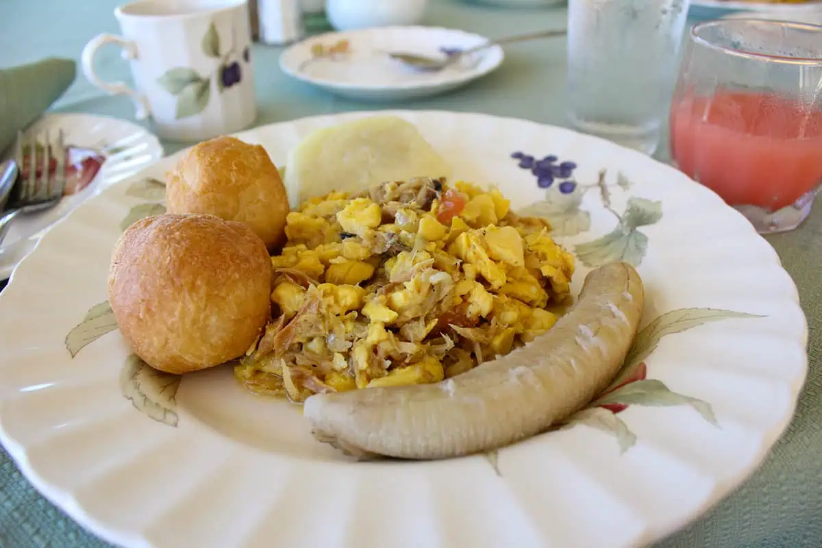 Plate of a typical Belizean breakfast featuring johnny cakes, providing a hearty start to the day in Belize.