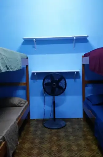 basic fan cooled dorm rooms at go slow guesthouse in caye caulker