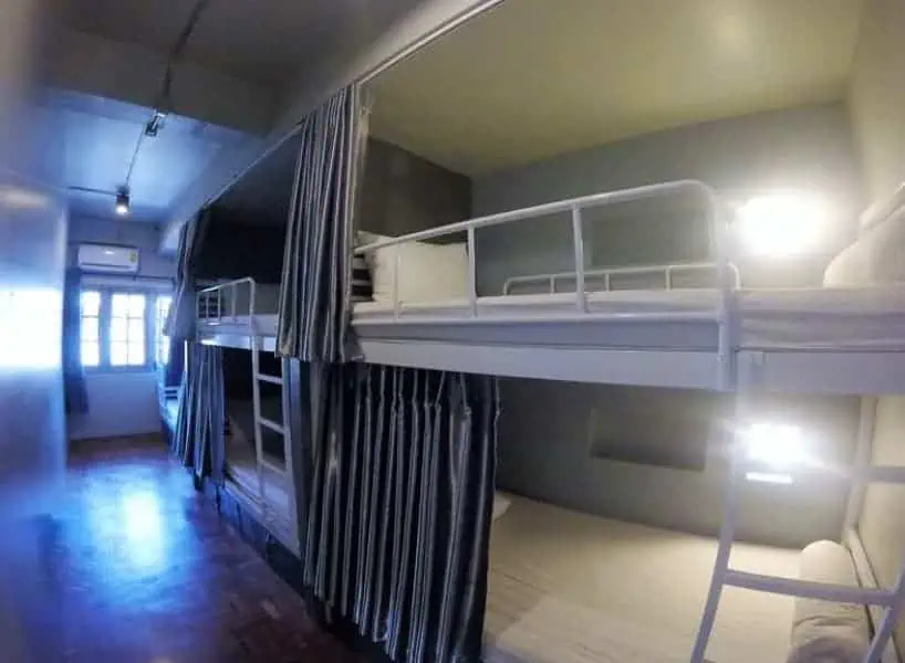 the dorm rooms at august hostel in chiang mai with curtains for privacy
