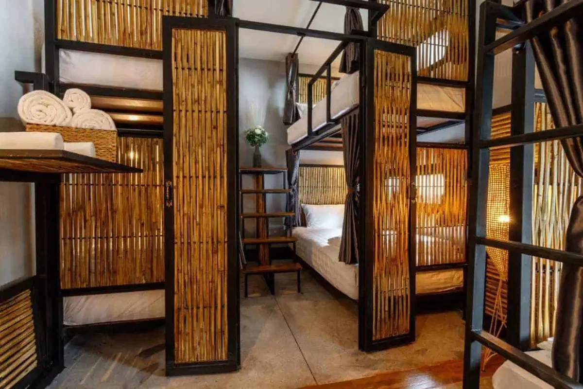 bamboo framed bunk beds with privacy curtains at hostel one art and gallery