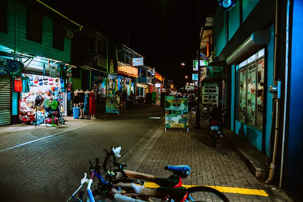 "Night view of a bustling street in San Ignacio showcasing the vibrant nightlife and cultural scene close to the hostel.