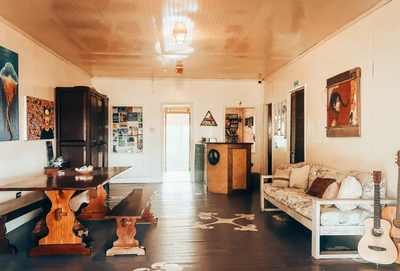 Spacious and homely common area with artistic decor and comfortable seating at Old House Hostel, known as one of the best hostels in San Ignacio.