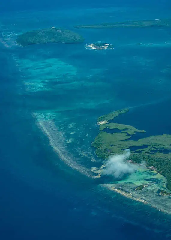 The majestic cayes of belize seen from above, highlighting the vivid coral reef formations and diverse marine life, a must-visit destination for snorkeling, one of the best things to do in Ambergris Caye.