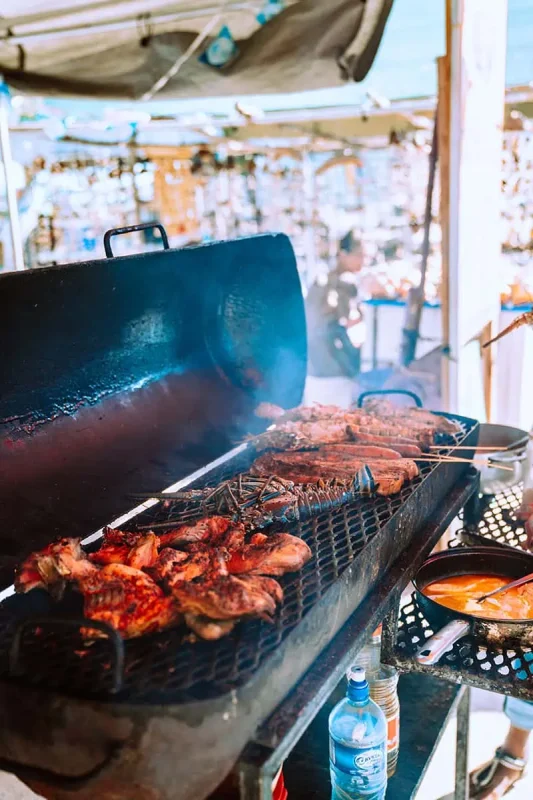 A sumptuous barbecue grill with various meats and seafood, representing the delicious local cuisine, a must-do for foodies in Ambergris Caye.