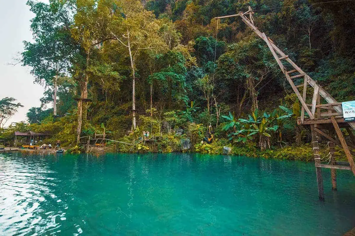 jumping off a rope swing a blue lagoon three in vang vieng