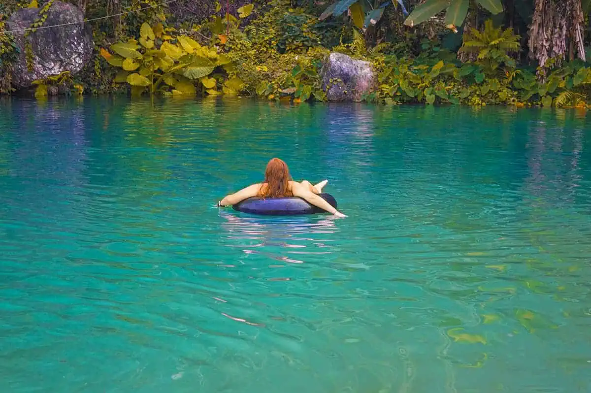 floating around on a tube at the blue lagoons in vang vieng