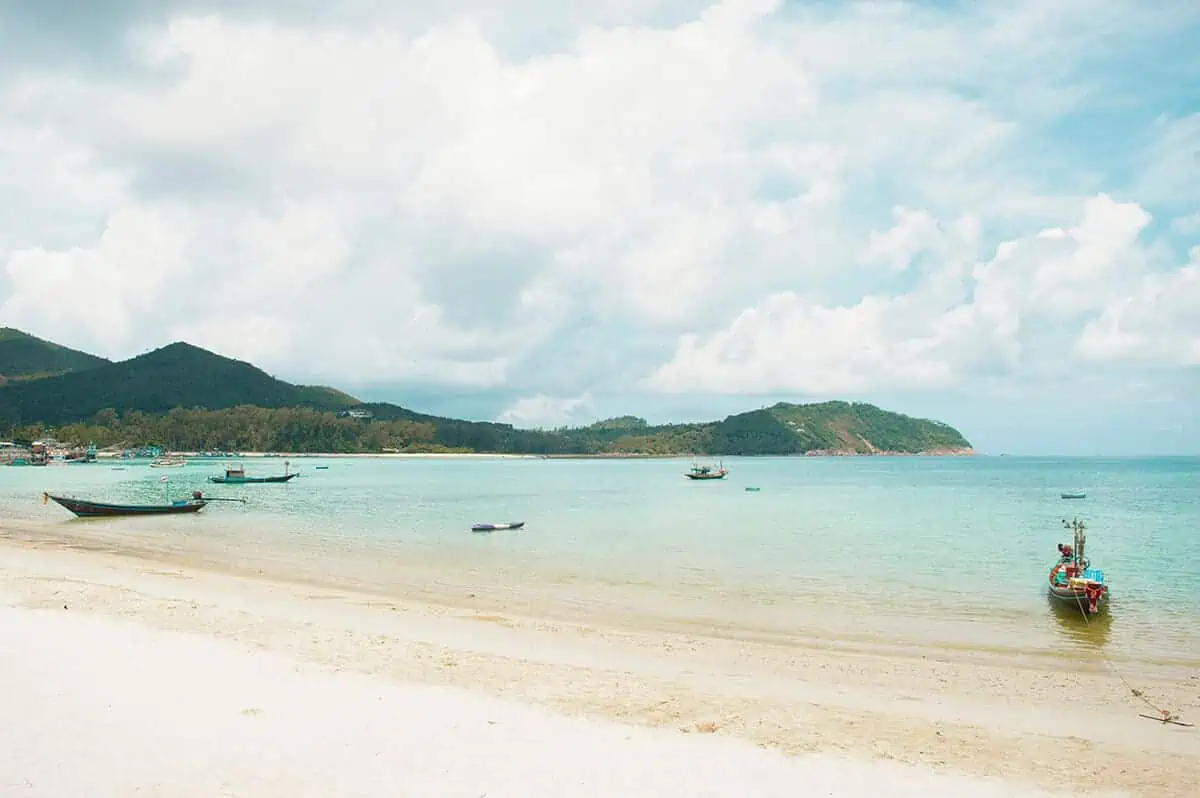 fishing boats lined up on the shallows of chaloklum beach in koh phangan