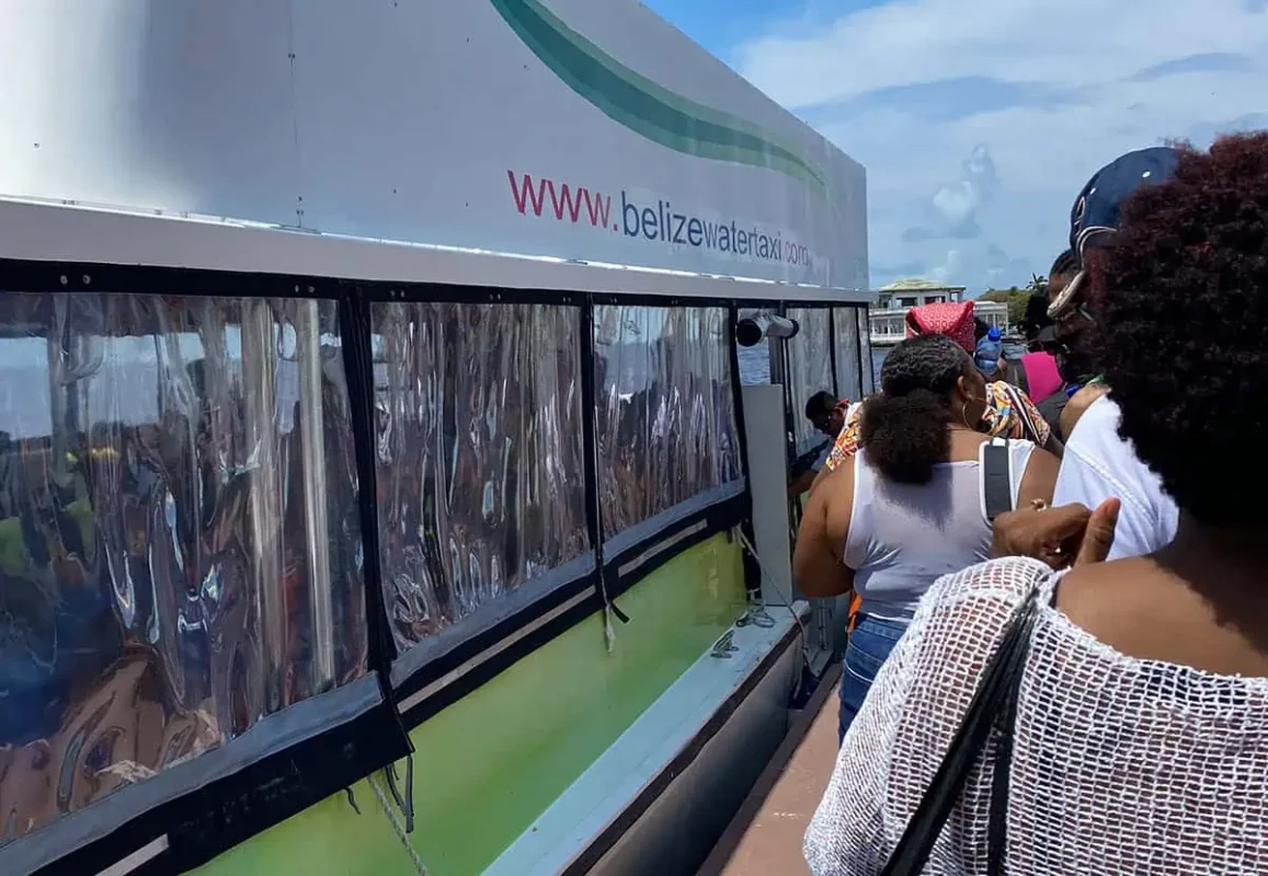 Chetumal To Caye Caulker: Best & Easiest Transport 2025 11 Passengers waiting in line to board the Belize Water Taxi ferry. The side of the ferry displays the website "www.belizewatertaxi.com" in bold letters. This vessel offers direct service from Chetumal to Caye Caulker, promising a scenic journey across the Caribbean Sea