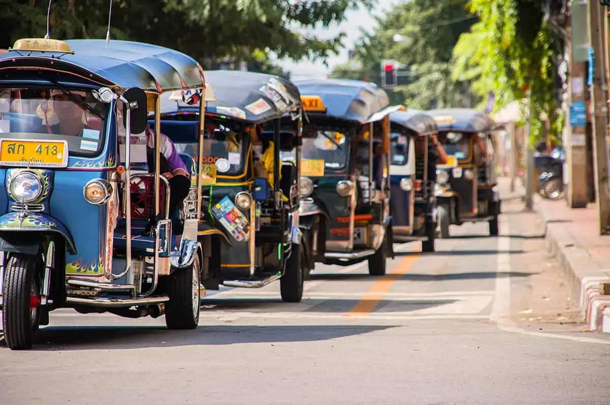 Chiang Mai Airport to City: Bus, TukTuk, Taxi, Or Walk? 15 a tuk tuk convoy in the streets of chiang mai