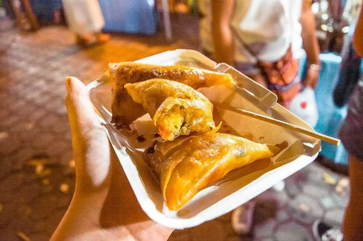 Freshly made samosas being served to eager foodies at a food stall in the Chiang Mai Sunday Market.