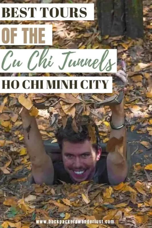 Best Cu Chi Tunnels Tours: Cheap VS Expensive 2025 18 Promotional image for tours of the Cu Chi Tunnels in Ho Chi Minh City, featuring a man emerging from a tunnel opening covered with fallen leaves, smiling excitedly towards the camera. Text overlay reads 'Best Tours of the Cu Chi Tunnels Ho Chi Minh City' with the website address 'www.backpackerswanderlust.com' at the bottom.