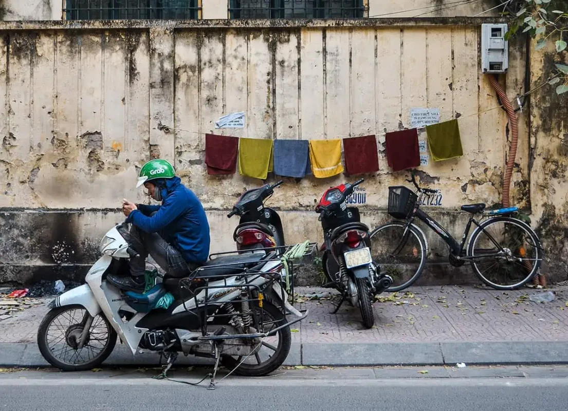 a grab driver on his phone waiting for customers in da nang