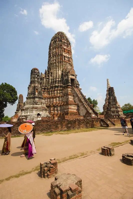 local ladies dressed in traditional clothes around Wat Chai Watthanaram prang