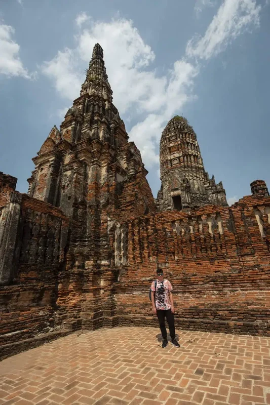 a man standing in front of Wat Chai Watthanaram