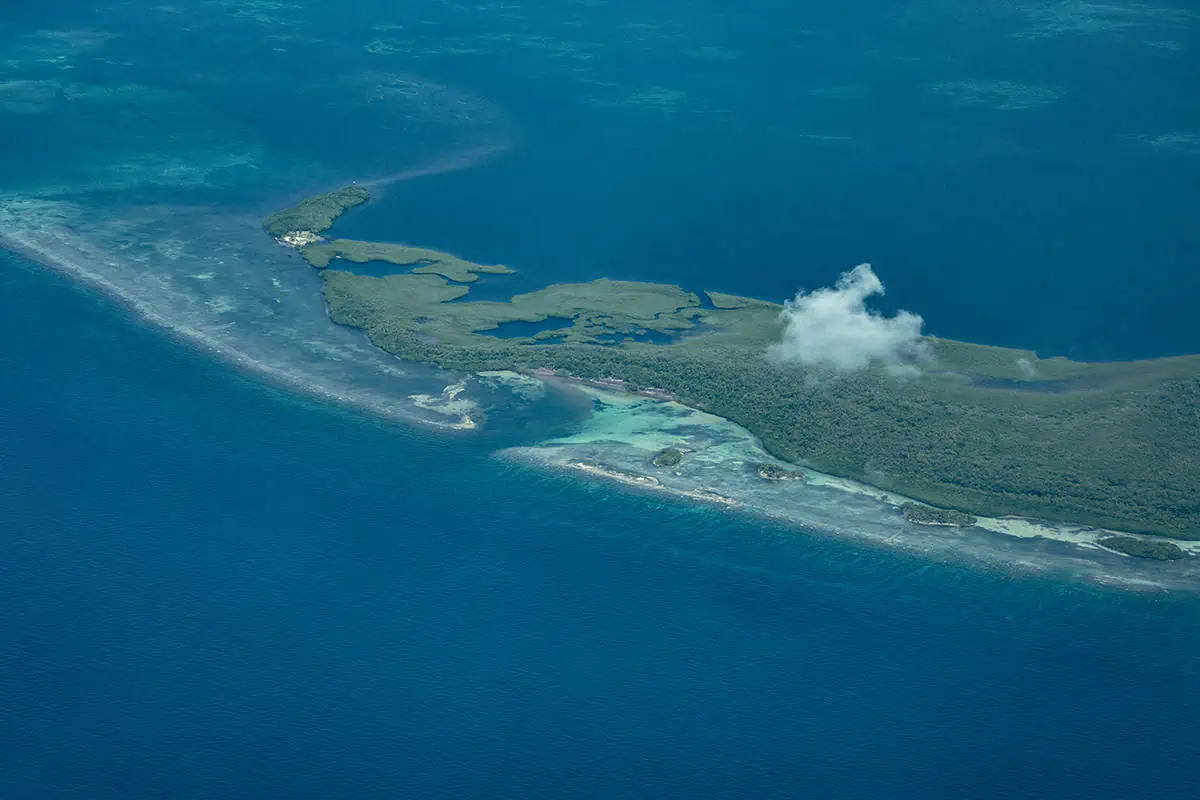 flying over an island between belize and honduras