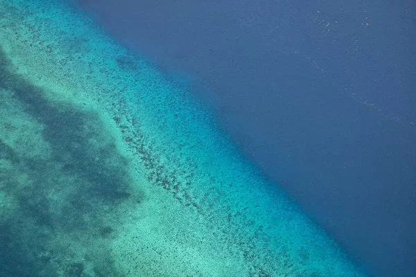 bright blue waters of the reef off the coast which you will find in both honduras vs belize