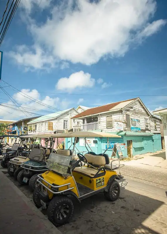 golf carts lined up on the street in san pedro ambergris caye