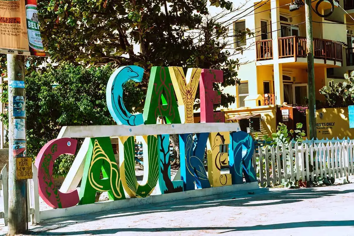 Colorful Caye Caulker sign adorned with marine life art, exemplifying the island's community spirit and safe, welcoming environment for visitors.