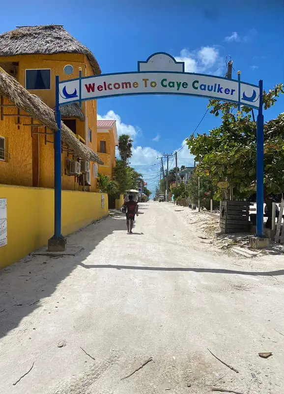 The welcoming entrance to Caye Caulker under a clear blue sky, reinforcing the island's safe and hospitable reputation