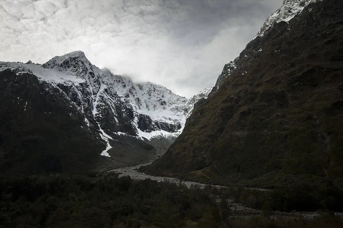 Snowy mountain peaks and rugged cliffs near the Homer Tunnel on the Milford Road.