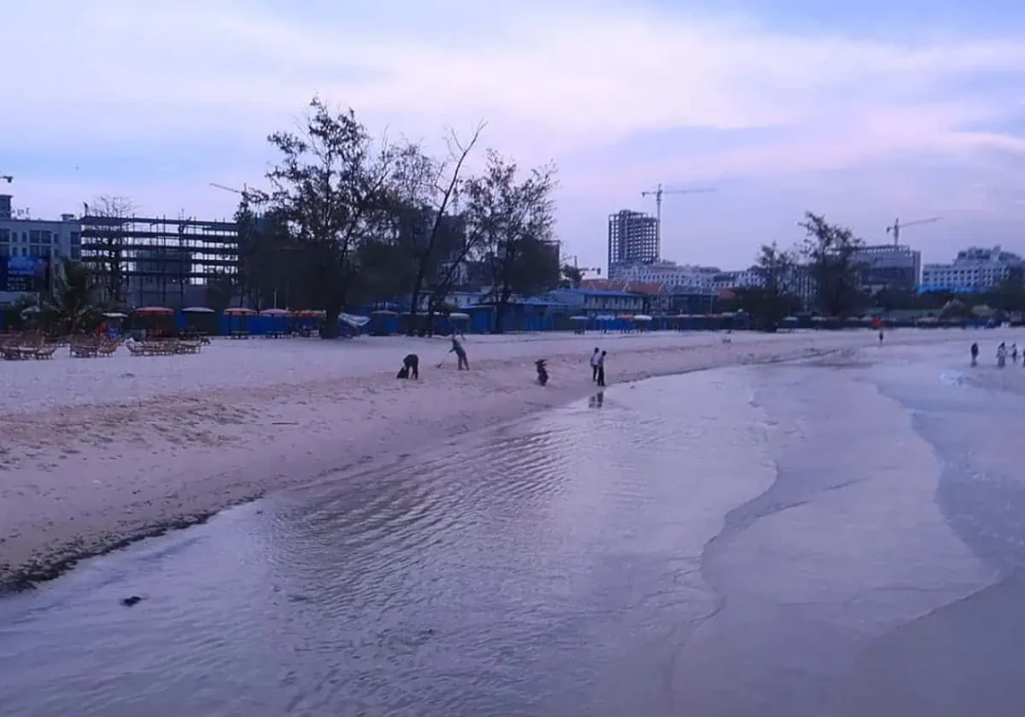 the main beach in sihanoukville being cleaned up from washed up rubbish
