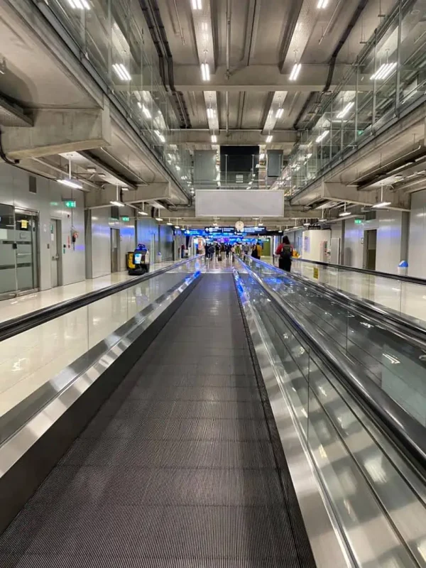 taking the moving walkway toward immigration at suvarnabhumi airport in bangkok