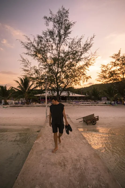 enjoying sunset on the pier at saracen bay in koh rong samloem