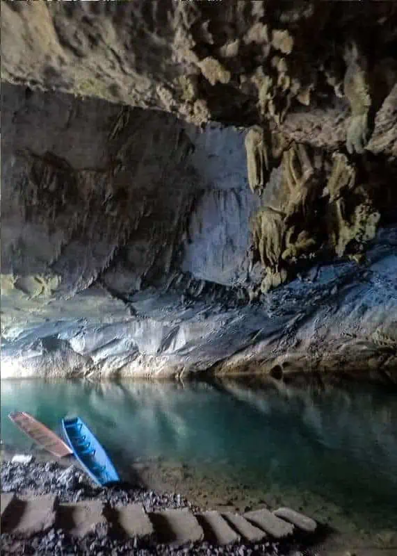 wooden long tail boats at the beginning of kong lor cave waiting for tourists