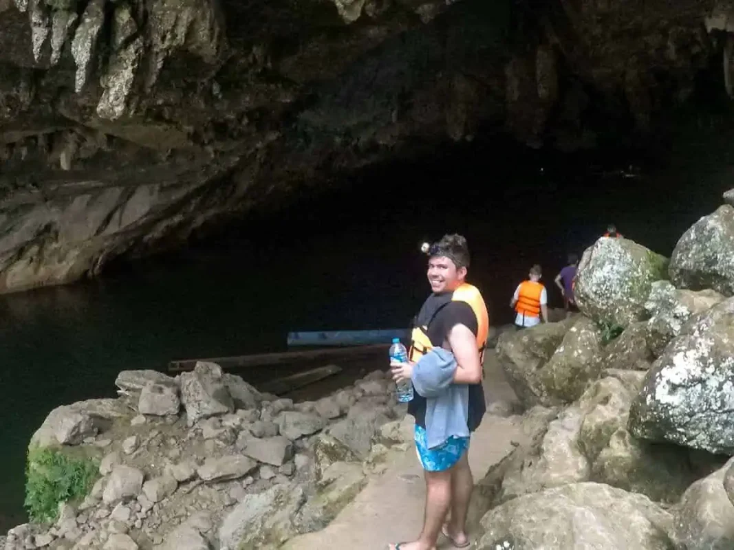 a man waiting to go on the boat inside tham kong lo