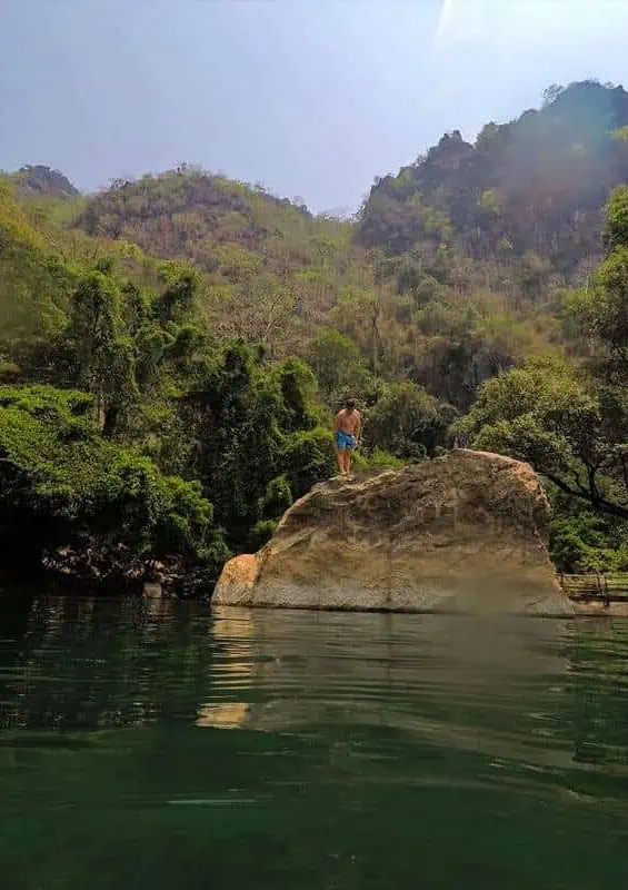 jumping off rocks into river at kong lor cave