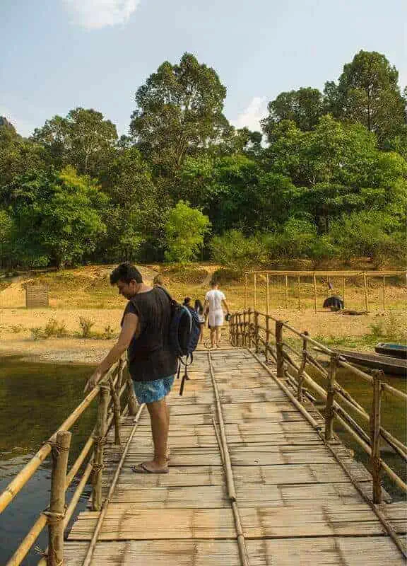 walking across the bamboo bridge above the nam hin bun river