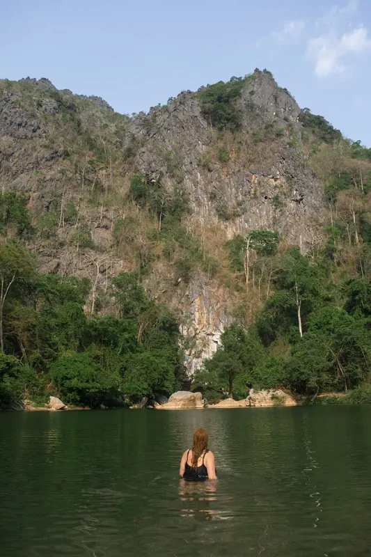 tasha amy is swimming in the water near kong lor cave in laos