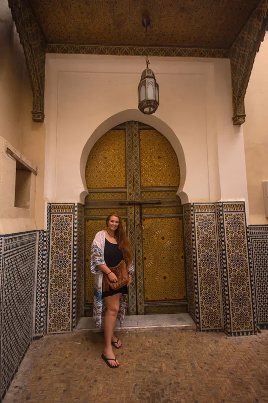 tasha amy standing in front of an ornate door in fes