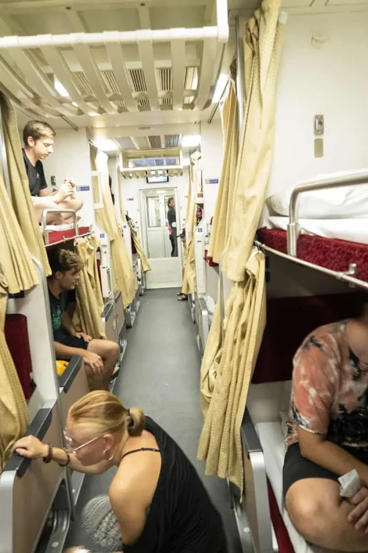 Passengers relaxing in their berths after setting up beds for the night on the sleeper train to Chiang Mai.