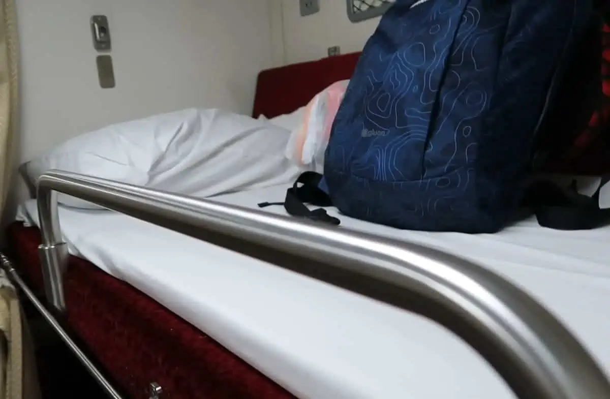 Interior view of the sleeper train showing beds set up for the night, after conversion from seating.