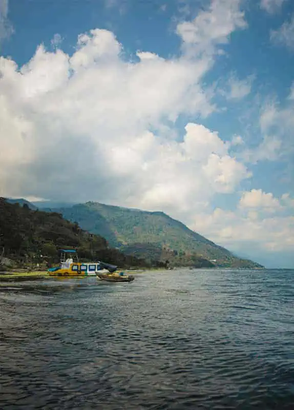 Panajachel To San Pedro & The Towns Between: How To Travel Around Lake Atitlan 41 two boats on the shores of lake atitlan