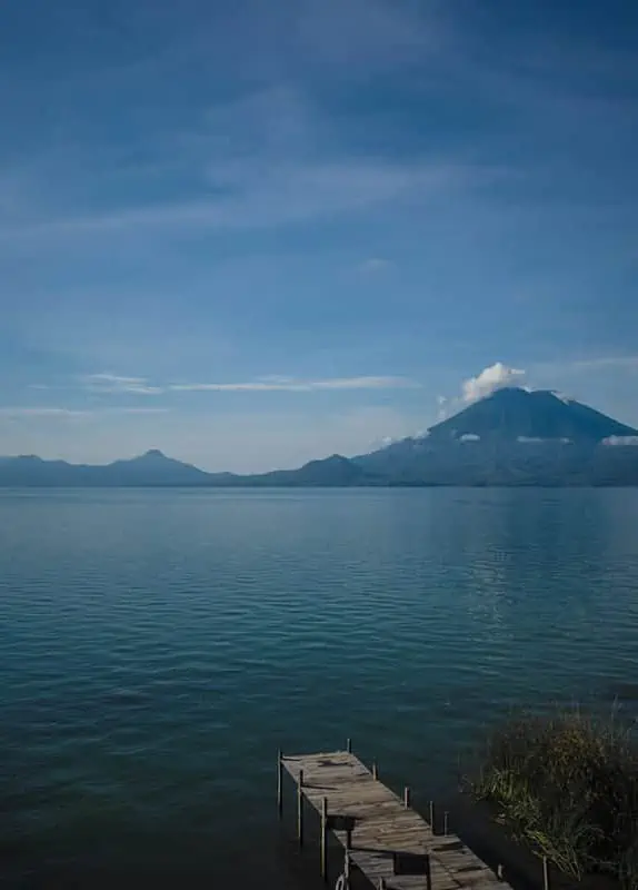 Panajachel To San Pedro & The Towns Between: How To Travel Around Lake Atitlan 40 looking out over a small pier to one of the volcanos