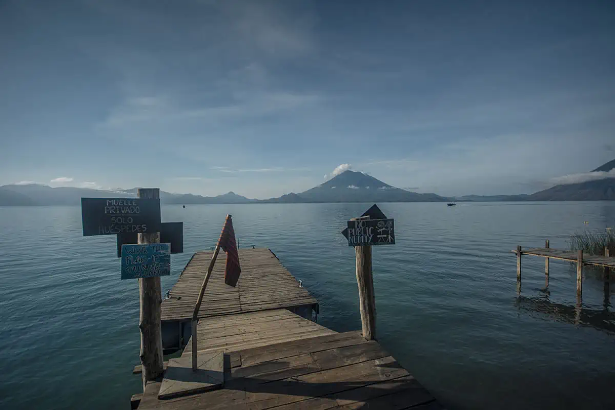 Panajachel To San Pedro & The Towns Between: How To Travel Around Lake Atitlan 43 signage and the flag to wave down water taxis at the pier in front of free cerveza hostel