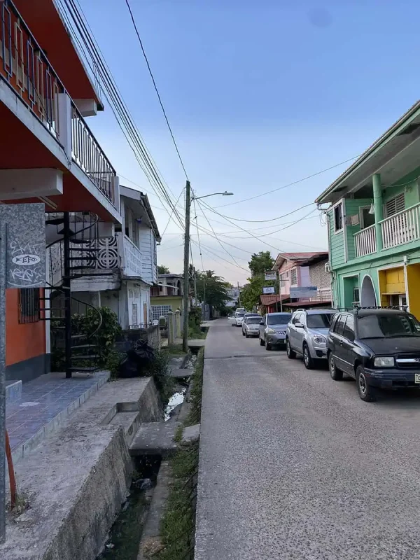 The quiet roads of San Ignacio lined with colorful houses and parked cars, the starting point for travelers heading to Tikal.