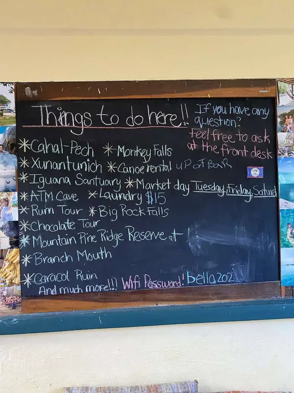 A chalkboard list of activities in San Ignacio, including tours to local attractions, showcasing the variety of adventures in the area.