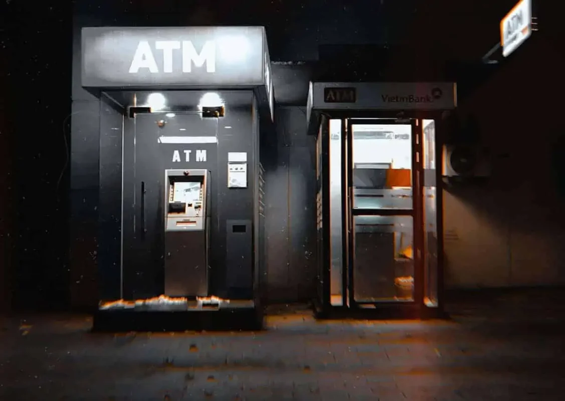 Scams In Vietnam: READ BEFORE YOU VISIT (2025) 19 Two brightly lit ATM booths at night, one branded VietinBank, standing alone in the dark.