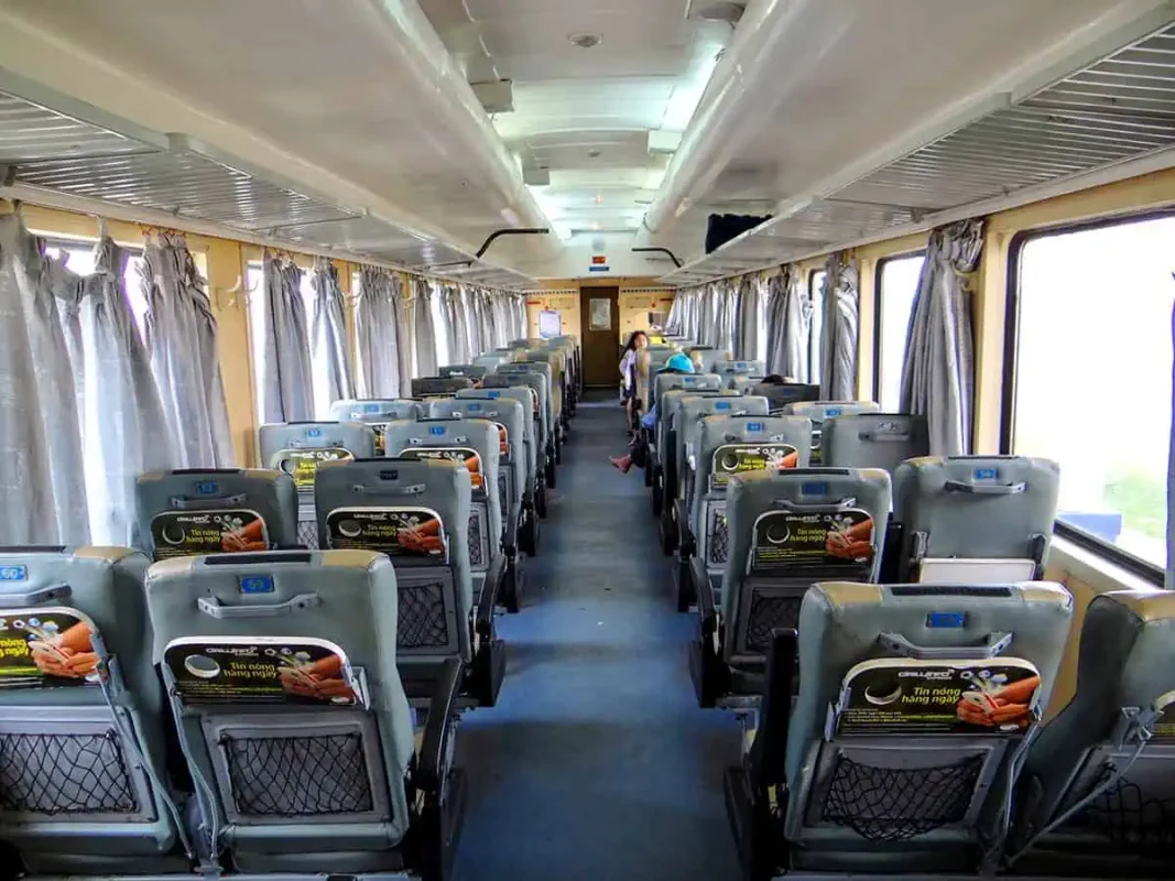 Interior view of a Vietnam overnight train carriage with soft seats 