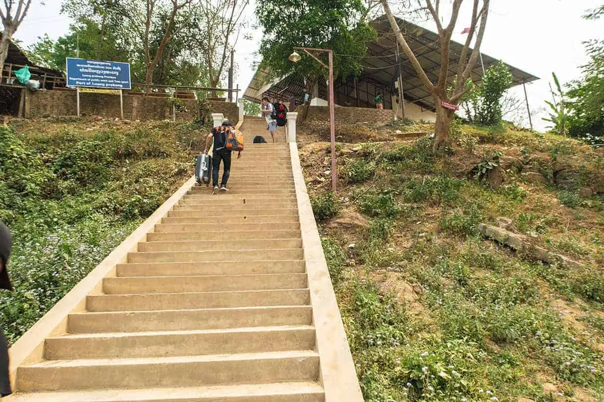 Passengers ascend the steps from the Mekong River having arrived in luang prabang
