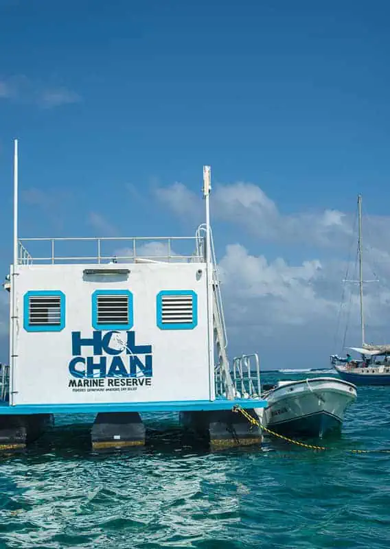 the ticket booth for hol chan marine reserve floating in the open water